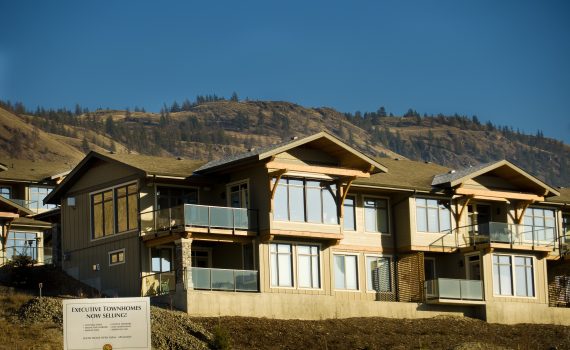View of town homes built in the Sun Rivers area of Kamloops in 2008 by member of TriAMM Developments showing hills and trees in background